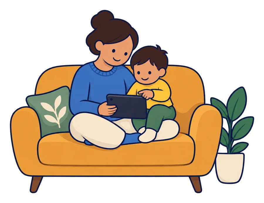 A parent and a toddler on a sofa, the toddler on the parent’s knee, looking at a tablet together.
